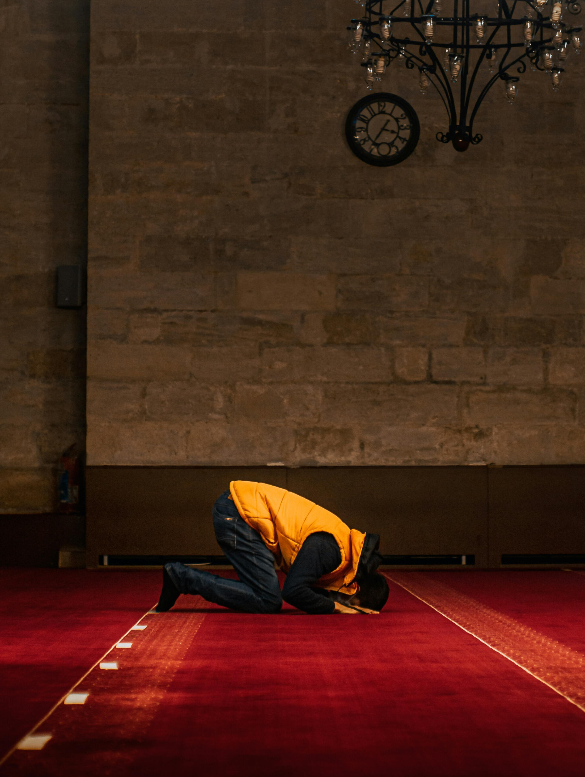 A Muslim man in prayer inside a mosque, reflecting the spiritual lives of expat Muslims living in Korea.